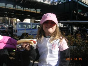 My daughter (then age 5) enjoying a dog after a day at Yankee Stadium